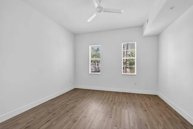 a view of empty room with wooden floor