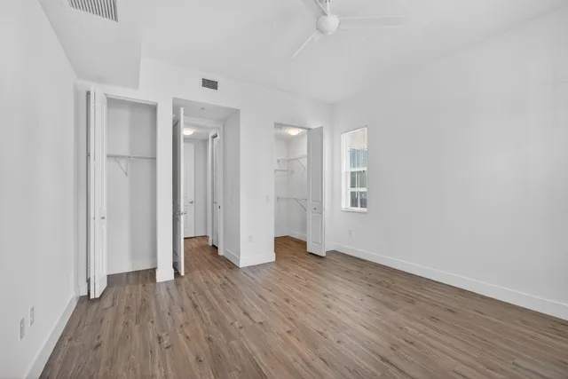 a bathroom with a granite countertop sink mirror and a toilet