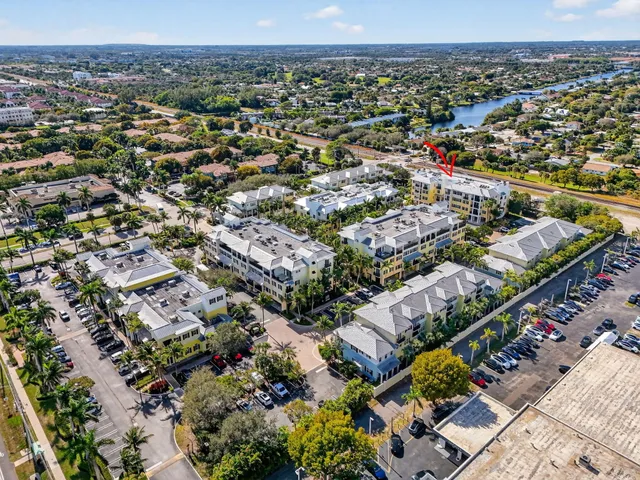a view of a patio with a table and chairs under an umbrella