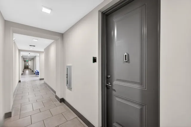 a view of a hallway with a wooden cabinets