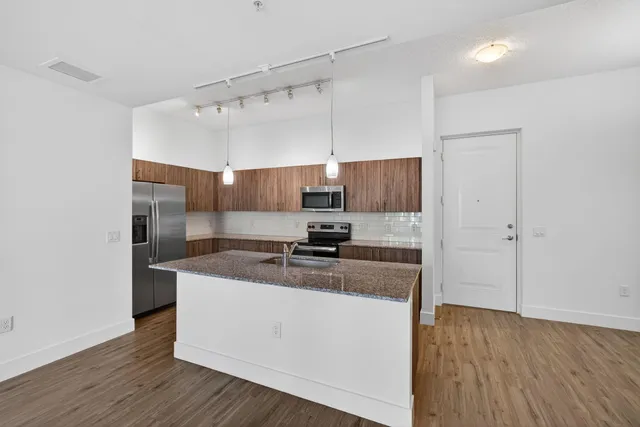 a kitchen with a sink and refrigerator