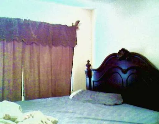 a bed sitting in a bedroom next to a wooden door