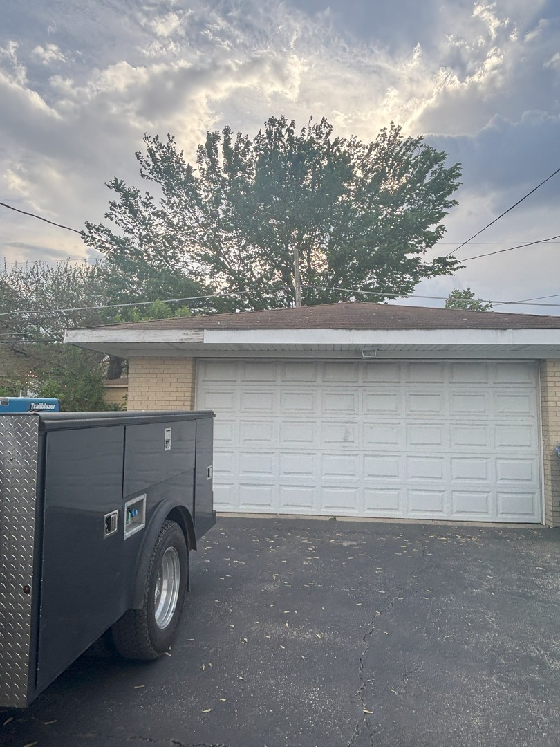 1514 Morris Avenue Berkeley, IL 60163 - Photo 4 of 4 a view of a car garage and a car parked in a parking lot