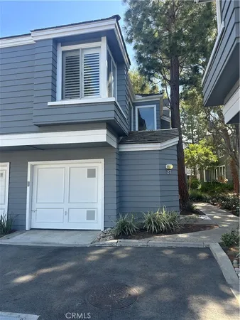 a house that has a tree in front of it