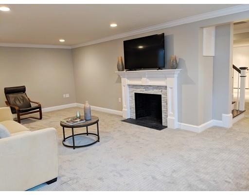 64 Bristol Road Wellesley, MA 02481 - Photo 25 of 28 a living room with furniture a fireplace and a flat screen tv