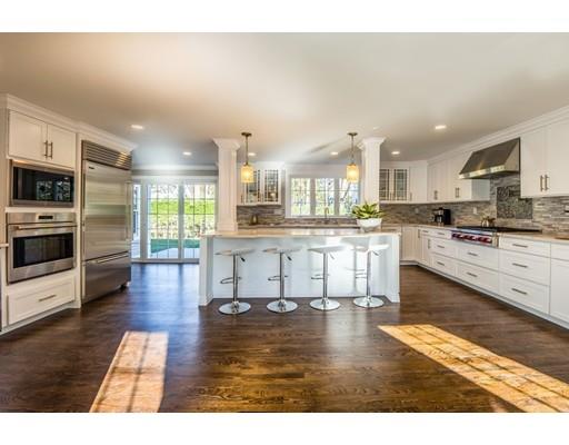 64 Bristol Road Wellesley, MA 02481 - Photo 3 of 28 a kitchen with stainless steel appliances kitchen island granite countertop a stove a sink a refrigerator white cabinets and wooden floor