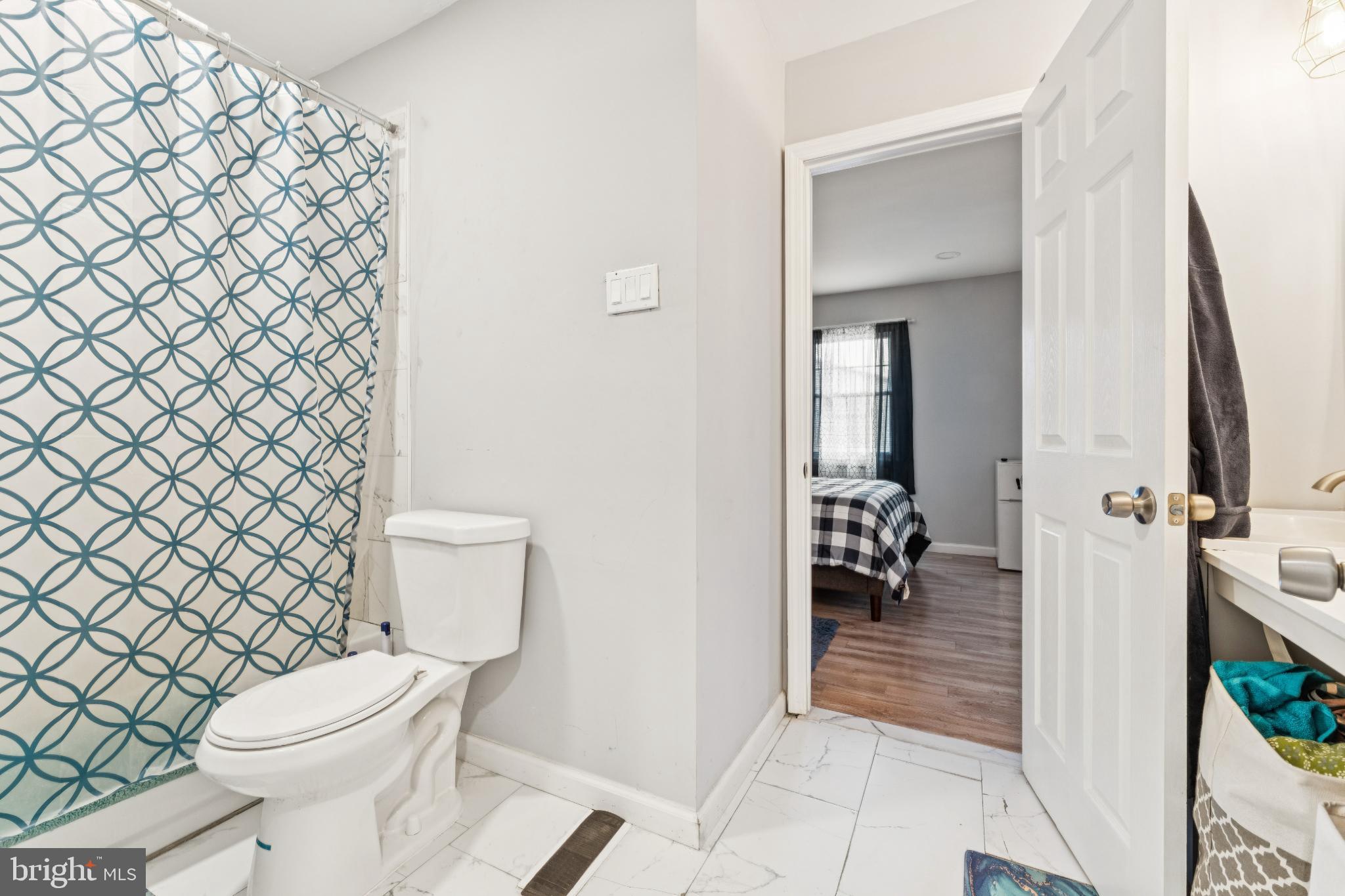 22 Milstone Court Sicklerville, NJ 08081 - Photo 13 of 26 a bathroom with a toilet and a shower curtain