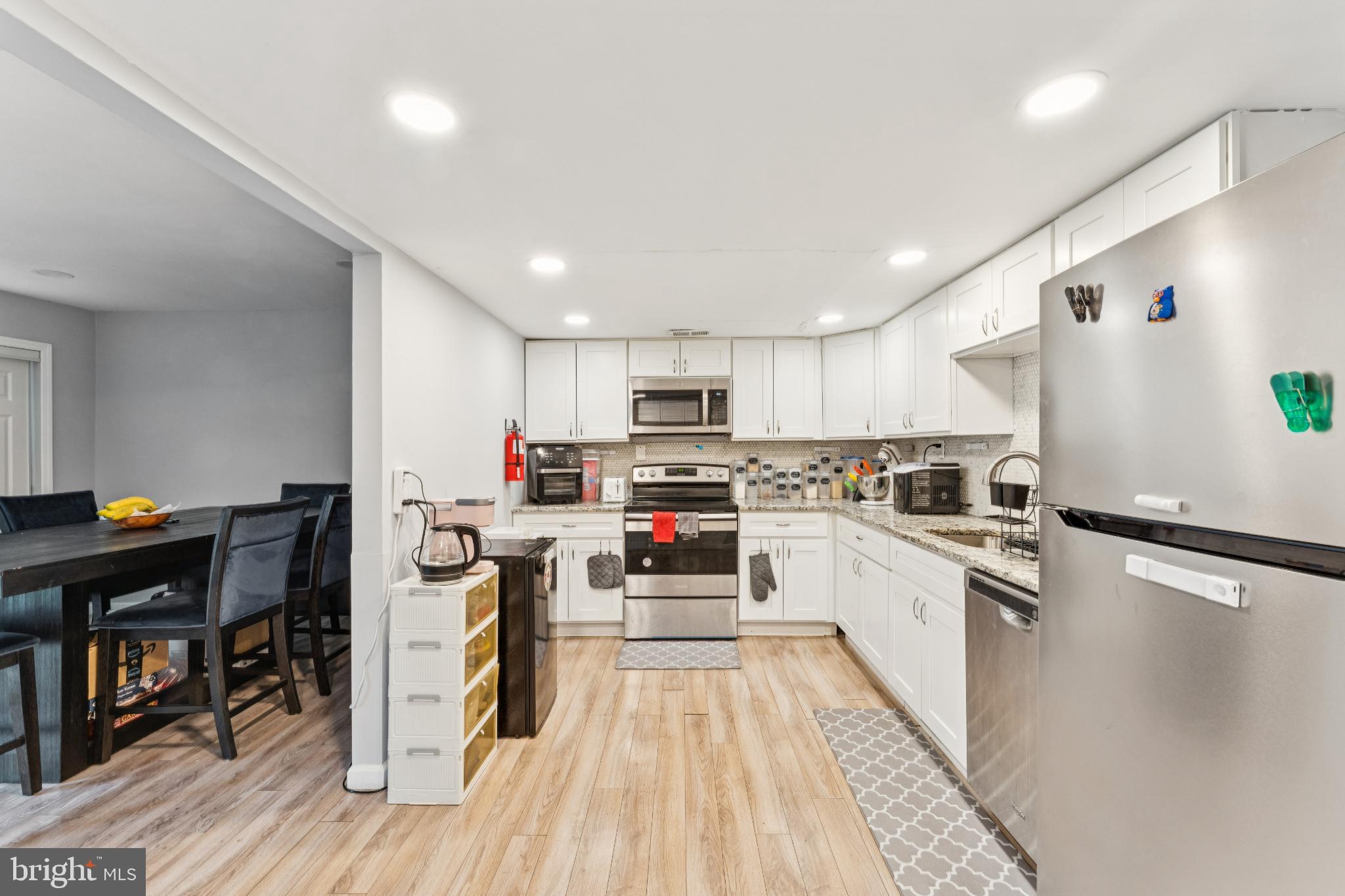 22 Milstone Court Sicklerville, NJ 08081 - Photo 2 of 26 a kitchen with white cabinets and stainless steel appliances