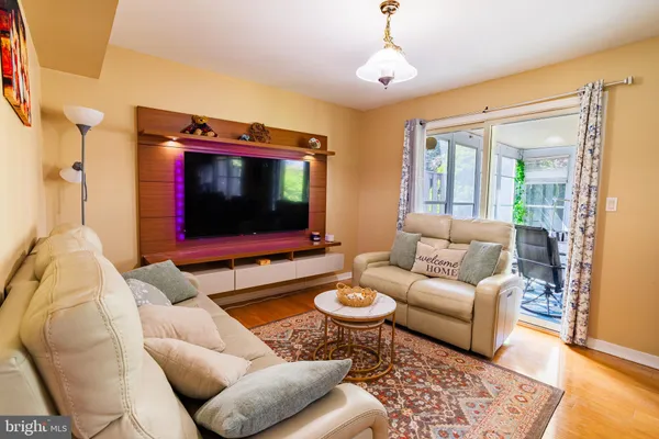 a living room with furniture and a flat screen tv