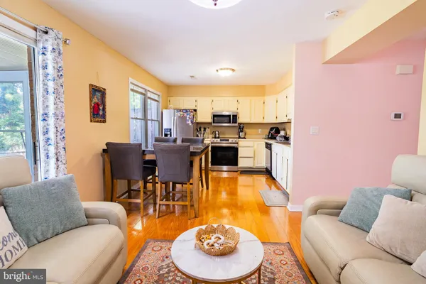 a dining room with furniture a kitchen view and a refrigerator