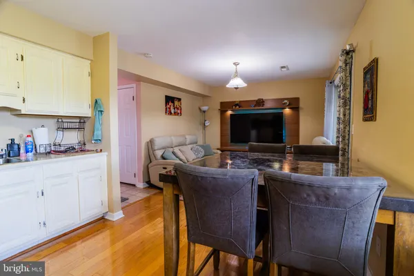 a kitchen with stainless steel appliances a refrigerator stove and white cabinets