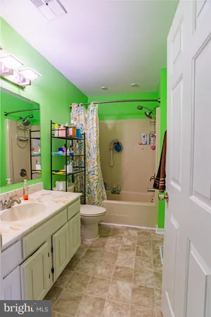 a view of a hallway with wooden floor and closet