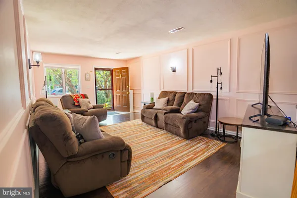 a living room with furniture window and a flat screen tv