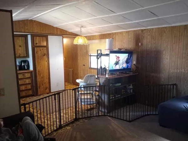 a living room with chairs and a fireplace