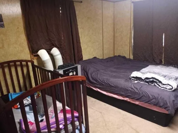 a bedroom with furniture and baby crib