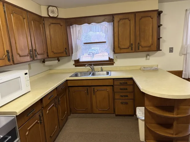 a kitchen with a sink cabinets and window