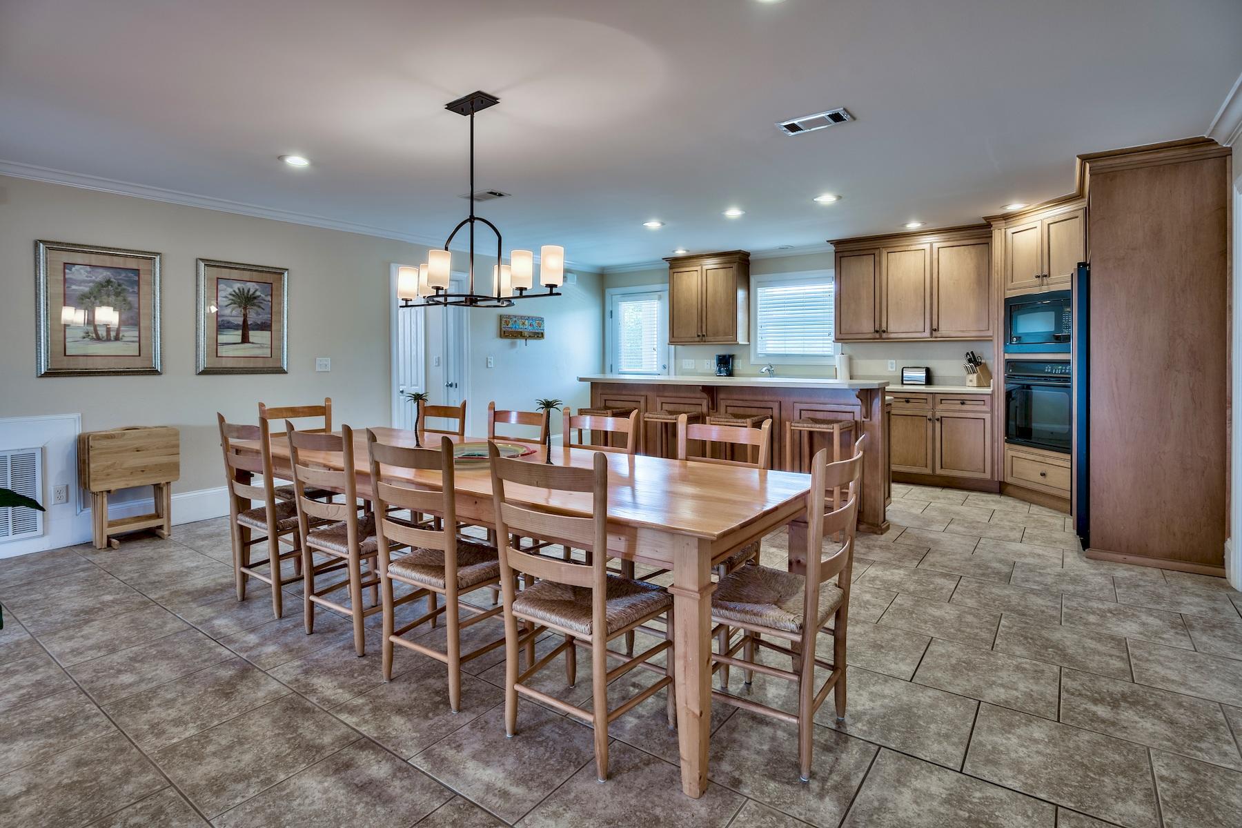 601 Blue Mountain Road Santa Rosa Beach, FL 32459 - Photo 12 of 51 a large kitchen with a table and chairs