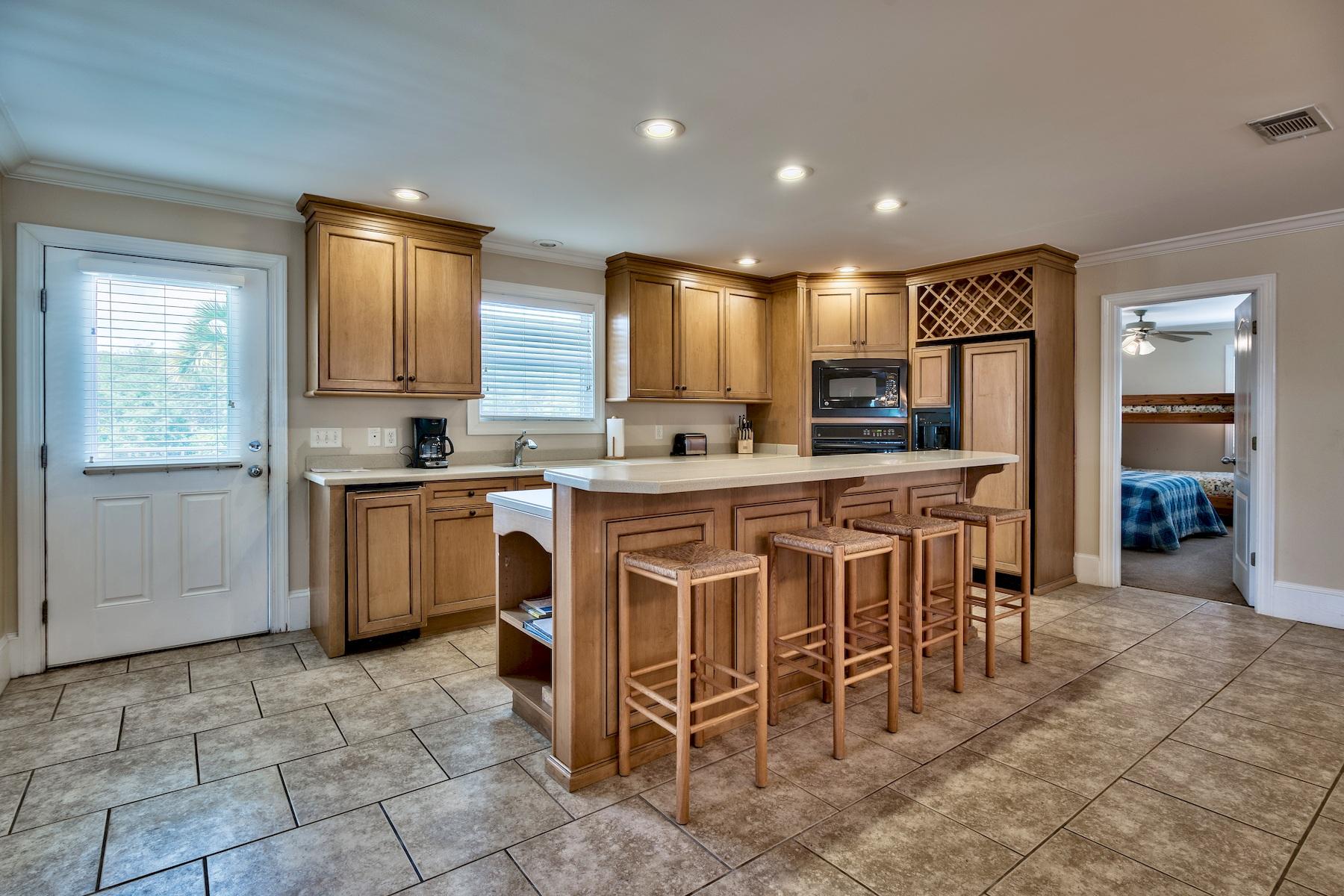 601 Blue Mountain Road Santa Rosa Beach, FL 32459 - Photo 13 of 51 a kitchen with kitchen island granite countertop counter top space appliances and a center island