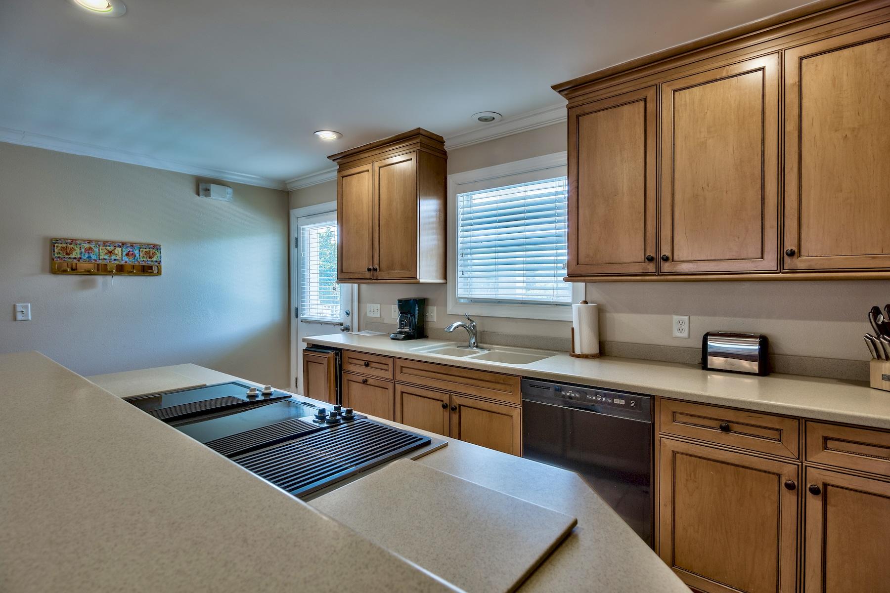 601 Blue Mountain Road Santa Rosa Beach, FL 32459 - Photo 14 of 51 a kitchen with a sink stove and cabinets