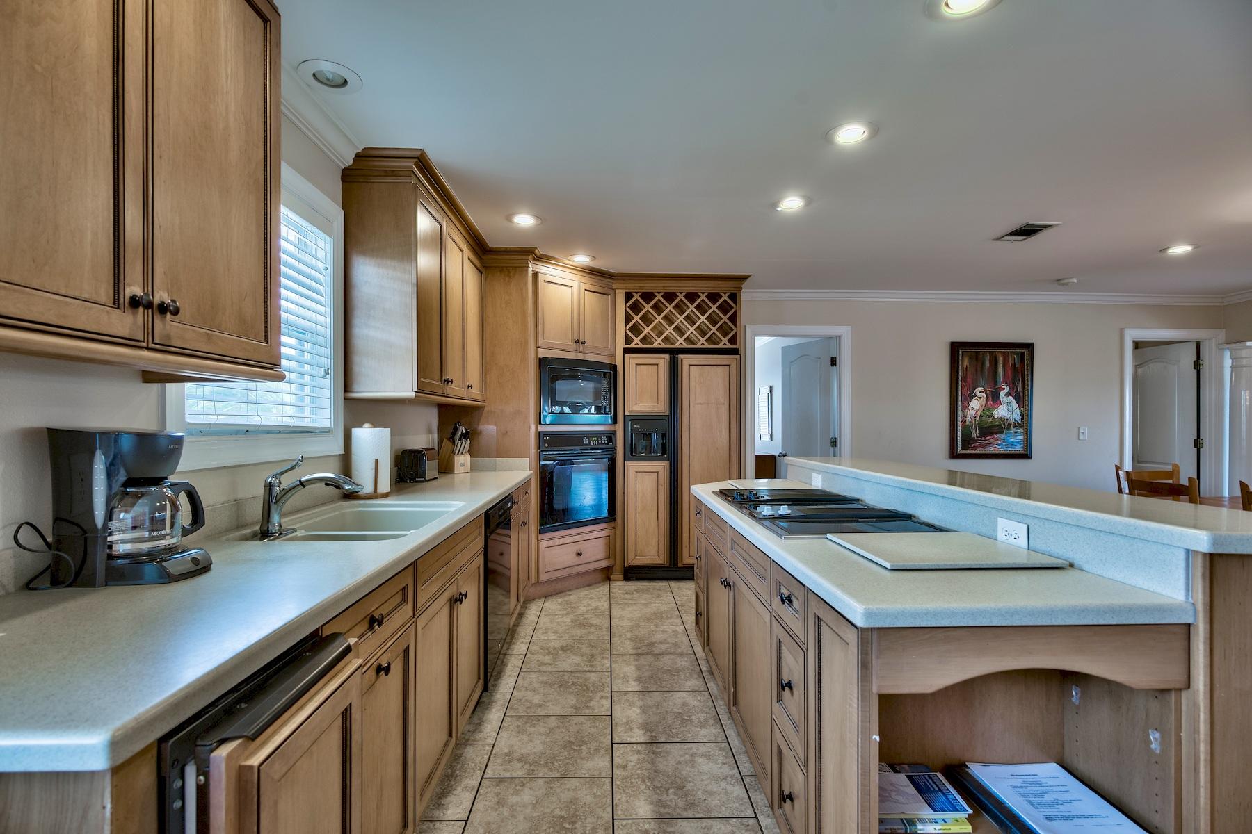 601 Blue Mountain Road Santa Rosa Beach, FL 32459 - Photo 15 of 51 a kitchen with stainless steel appliances granite countertop a sink stove and cabinets