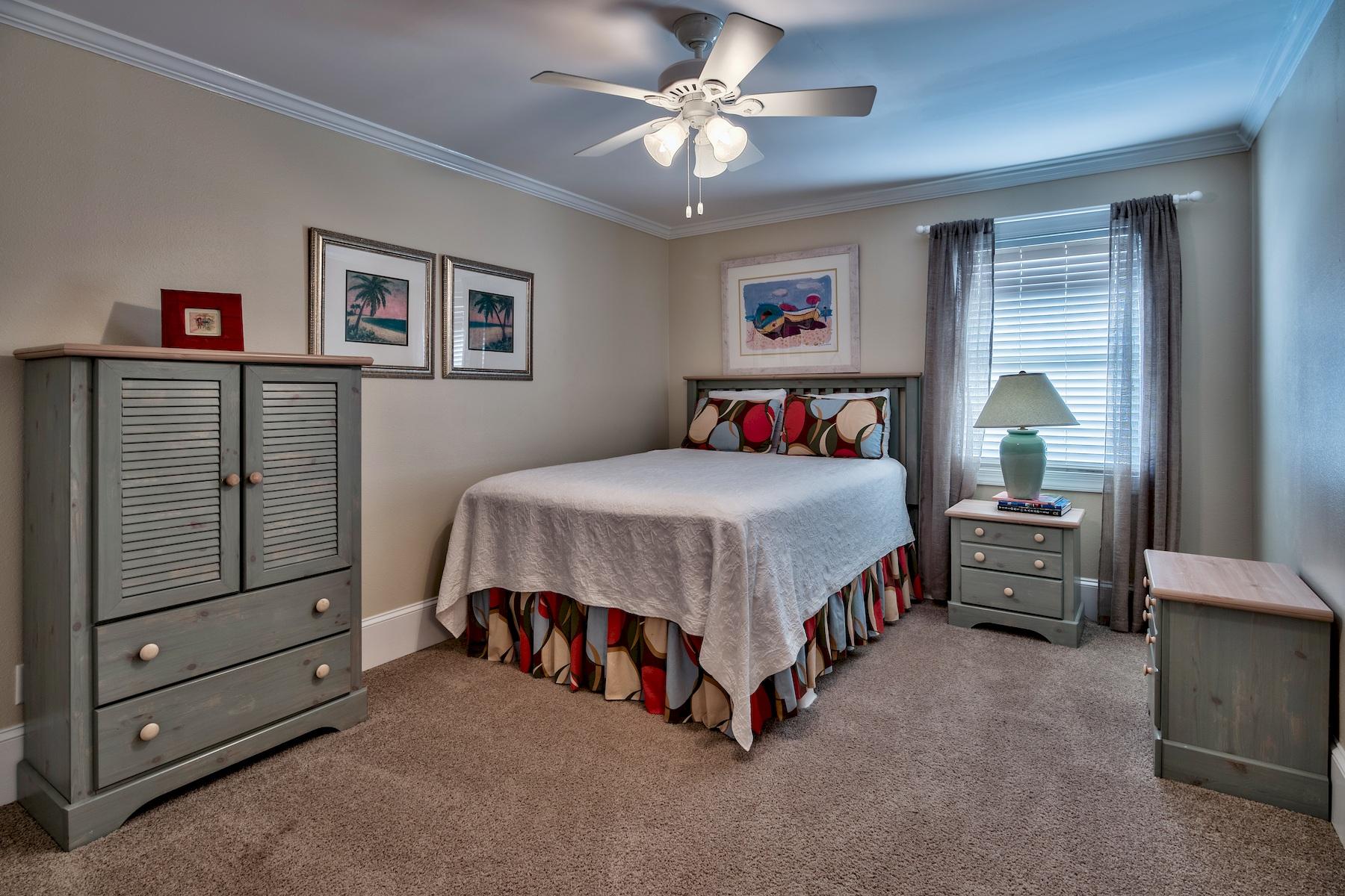 601 Blue Mountain Road Santa Rosa Beach, FL 32459 - Photo 18 of 51 a bedroom with a bed and a chandelier