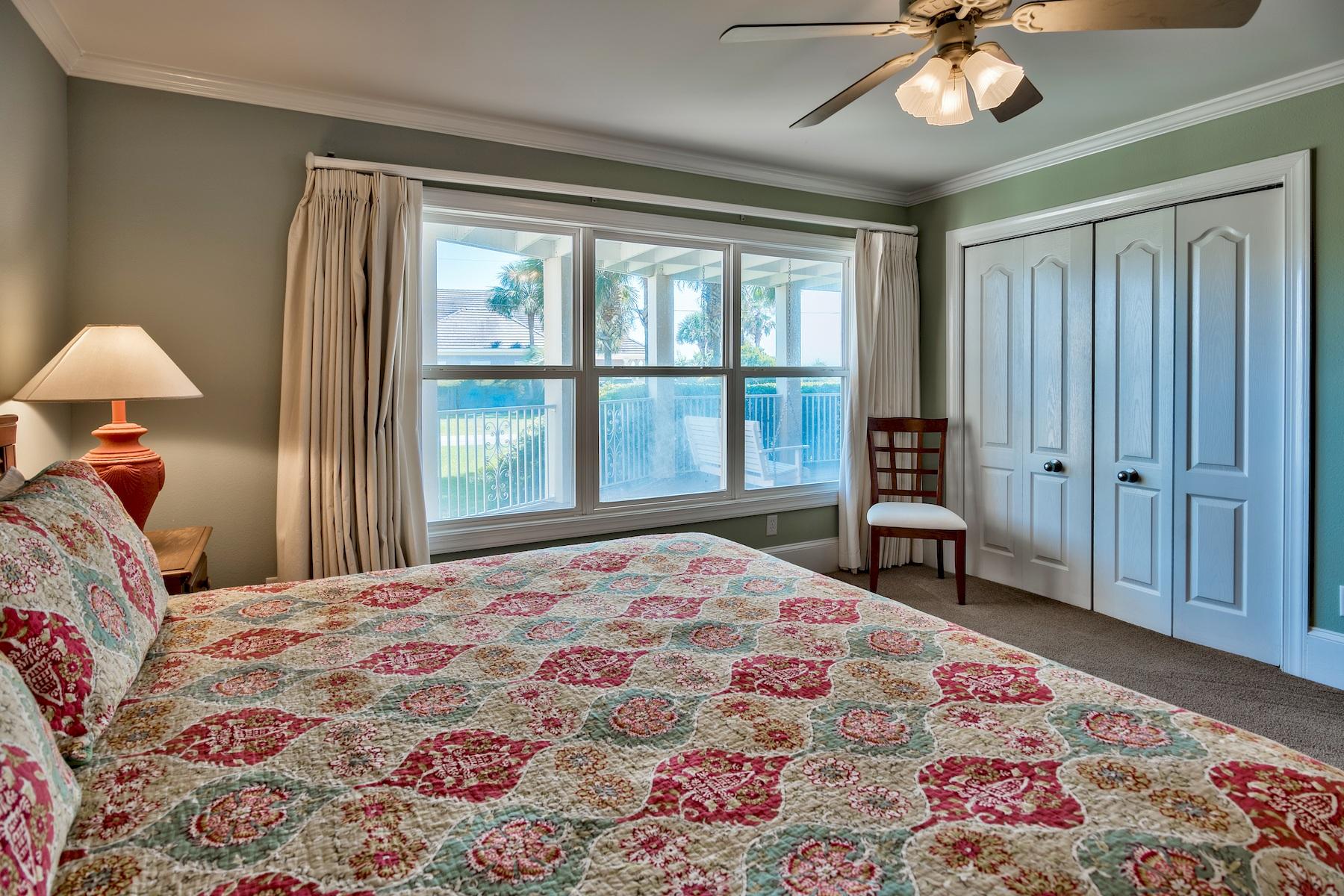 601 Blue Mountain Road Santa Rosa Beach, FL 32459 - Photo 20 of 51 a bedroom with a bed and a chandelier