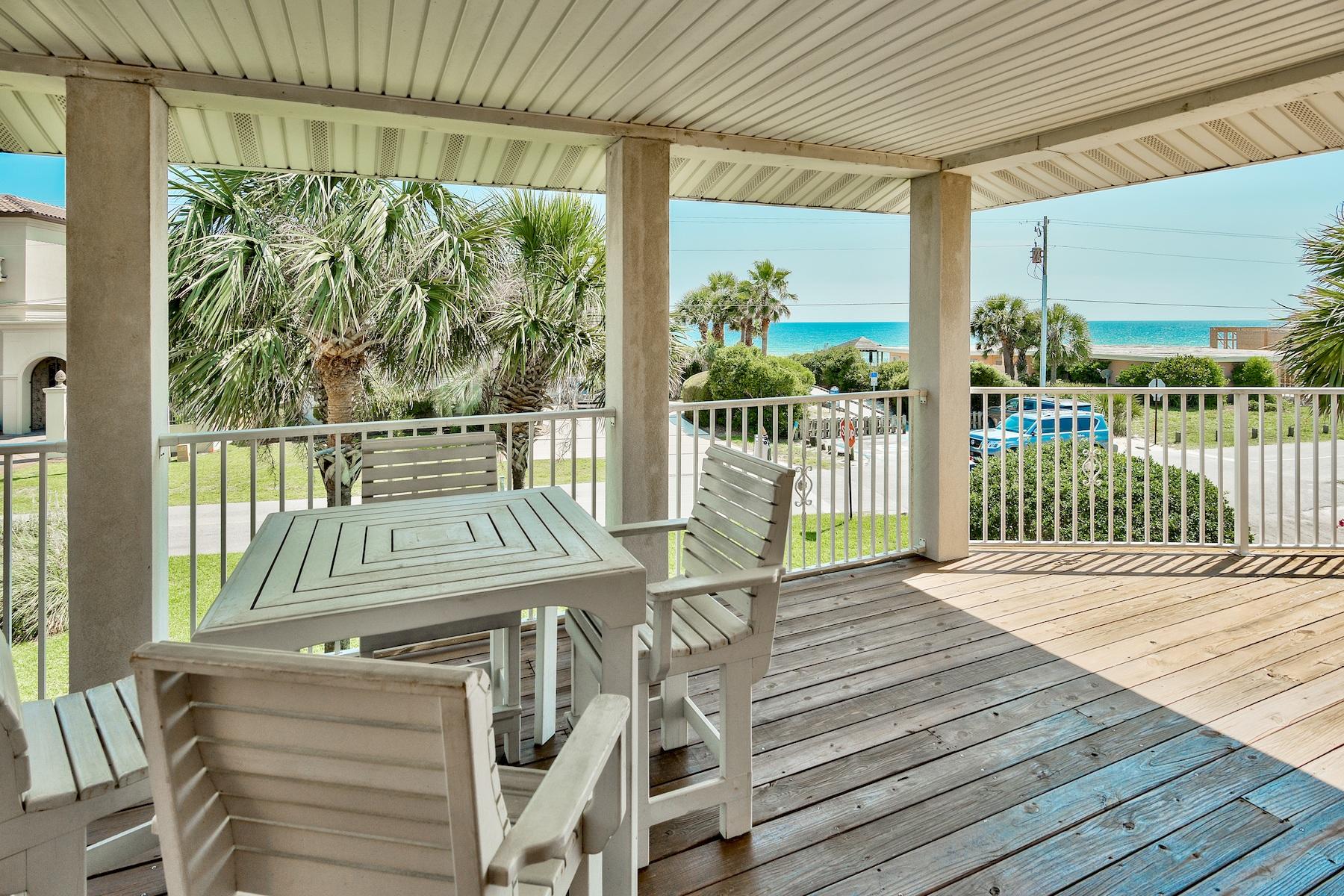 601 Blue Mountain Road Santa Rosa Beach, FL 32459 - Photo 27 of 51 a view of a patio with a table chairs and wooden floor