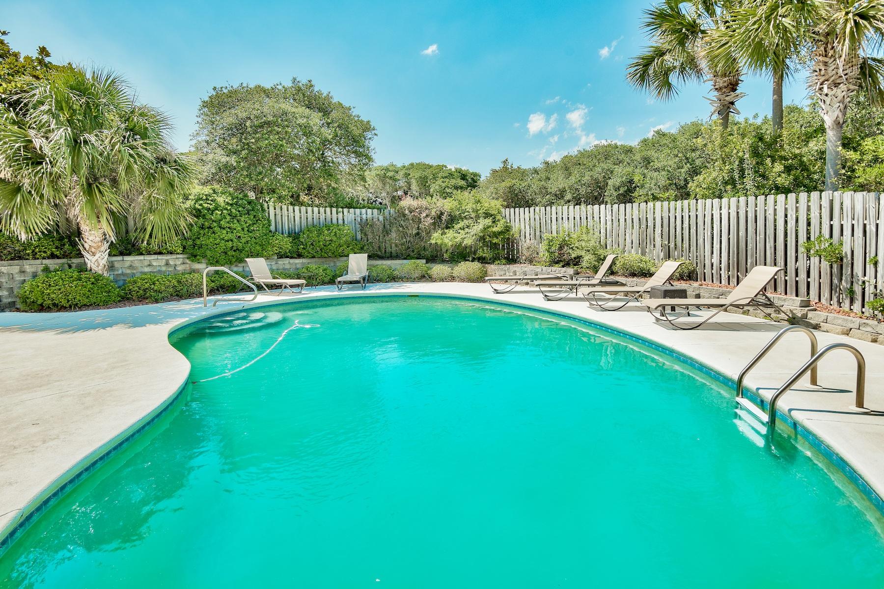 601 Blue Mountain Road Santa Rosa Beach, FL 32459 - Photo 33 of 51 a view of a swimming pool with a patio and a garden