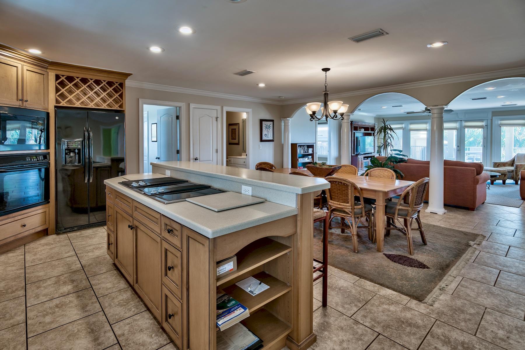 601 Blue Mountain Road Santa Rosa Beach, FL 32459 - Photo 34 of 51 a kitchen with stainless steel appliances granite countertop a stove a refrigerator a dining table and chairs