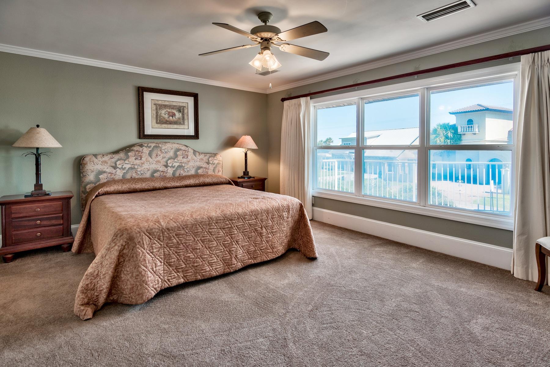 601 Blue Mountain Road Santa Rosa Beach, FL 32459 - Photo 40 of 51 a bedroom with a large bed and a chandelier fan