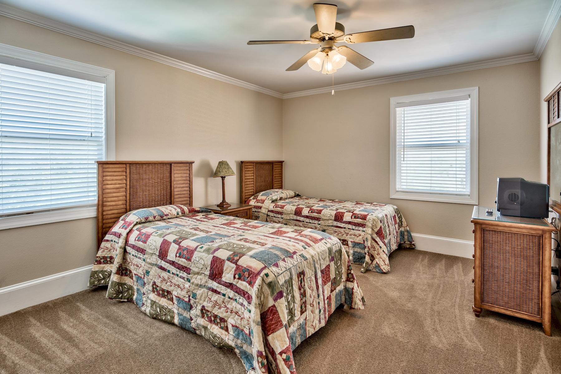 601 Blue Mountain Road Santa Rosa Beach, FL 32459 - Photo 44 of 51 a bedroom with a bed and a ceiling fan