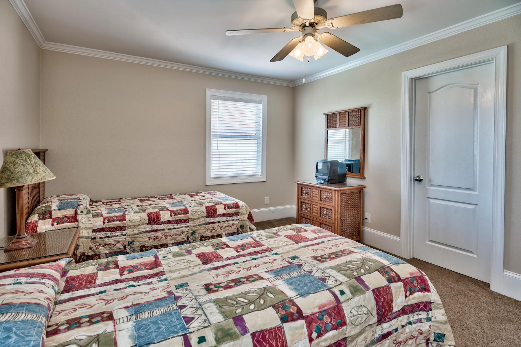 601 Blue Mountain Road Santa Rosa Beach, FL 32459 - Photo 45 of 51 a bedroom with a bed and a chandelier