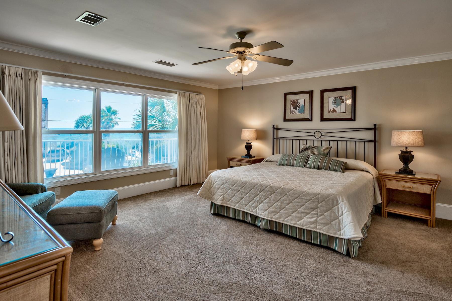 601 Blue Mountain Road Santa Rosa Beach, FL 32459 - Photo 46 of 51 a spacious bedroom with a large bed and a chandelier