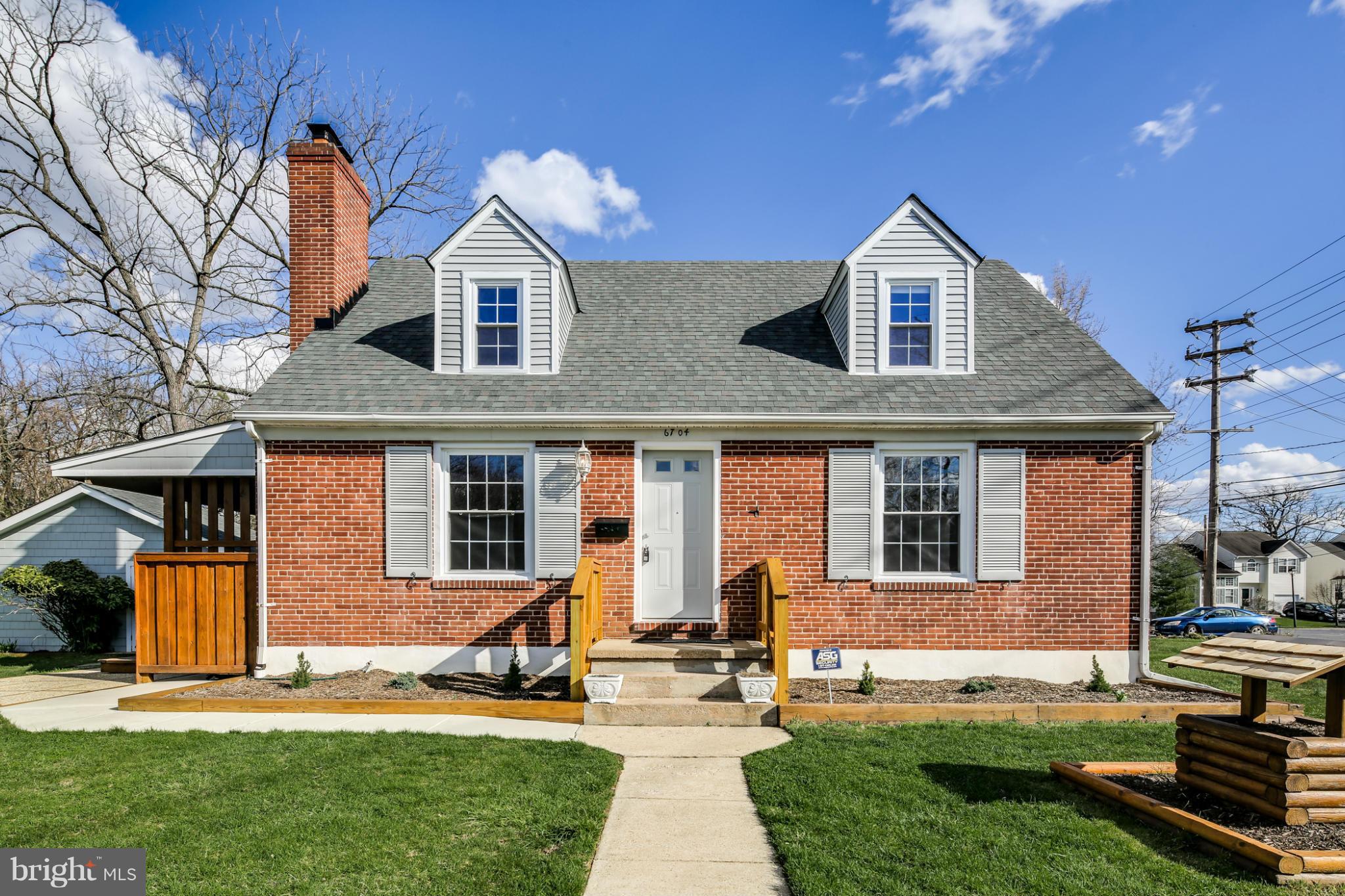 6704 Campfield Road Baltimore, MD 21207 - Photo 1 of 30 a front view of a house with a yard and garage