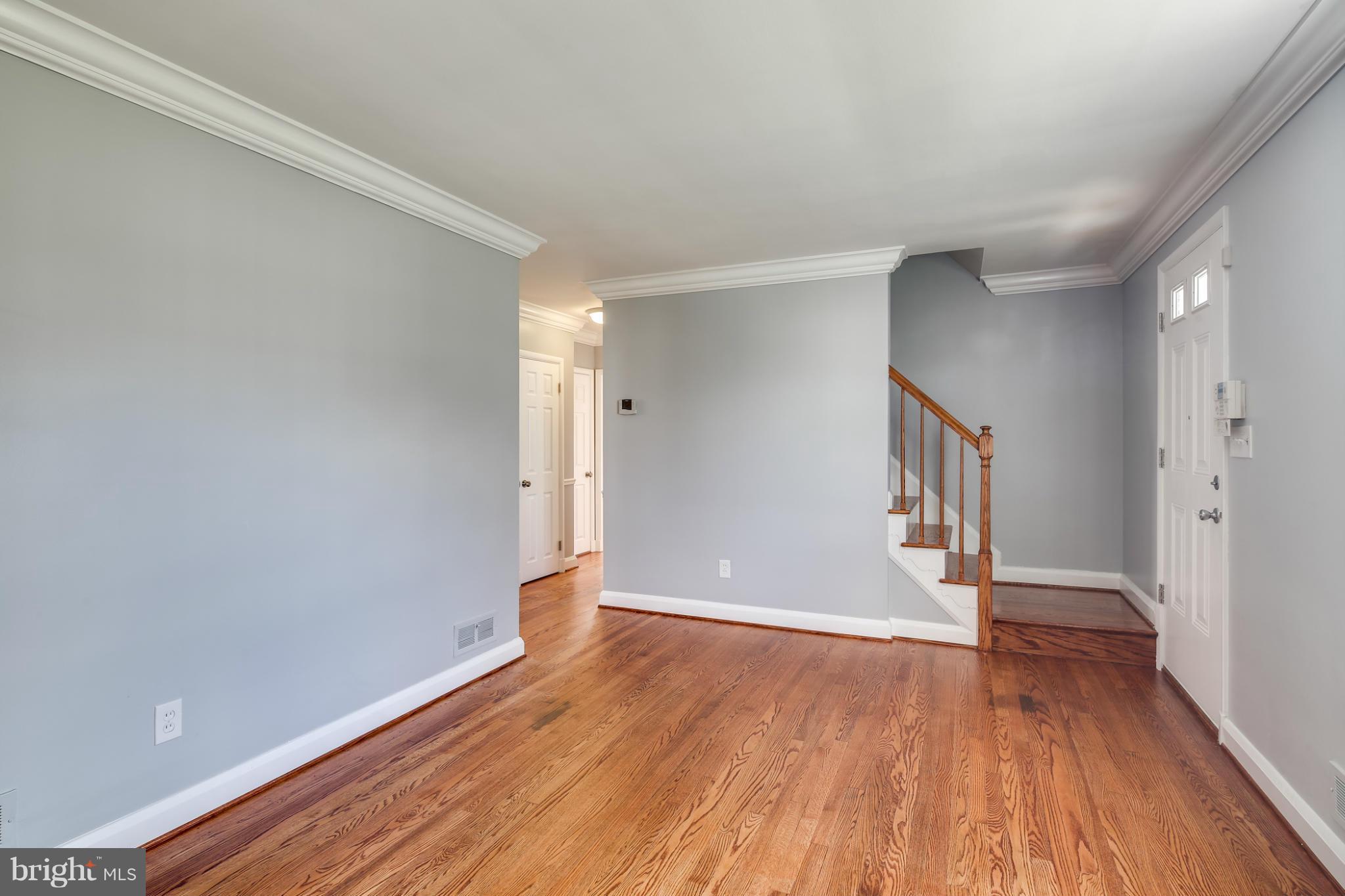 6704 Campfield Road Baltimore, MD 21207 - Photo 12 of 30 a view of an empty room with wooden floor