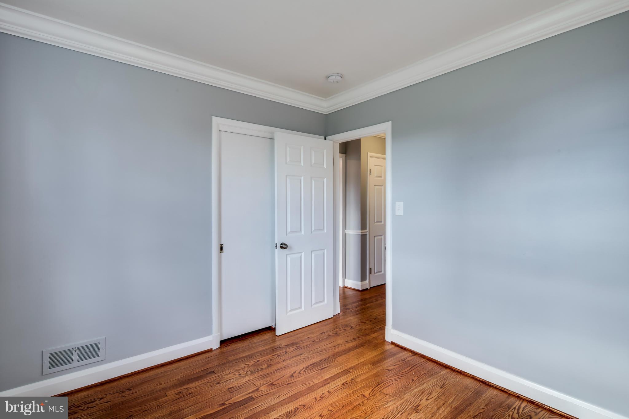 6704 Campfield Road Baltimore, MD 21207 - Photo 14 of 30 a view of an empty room with wooden floor