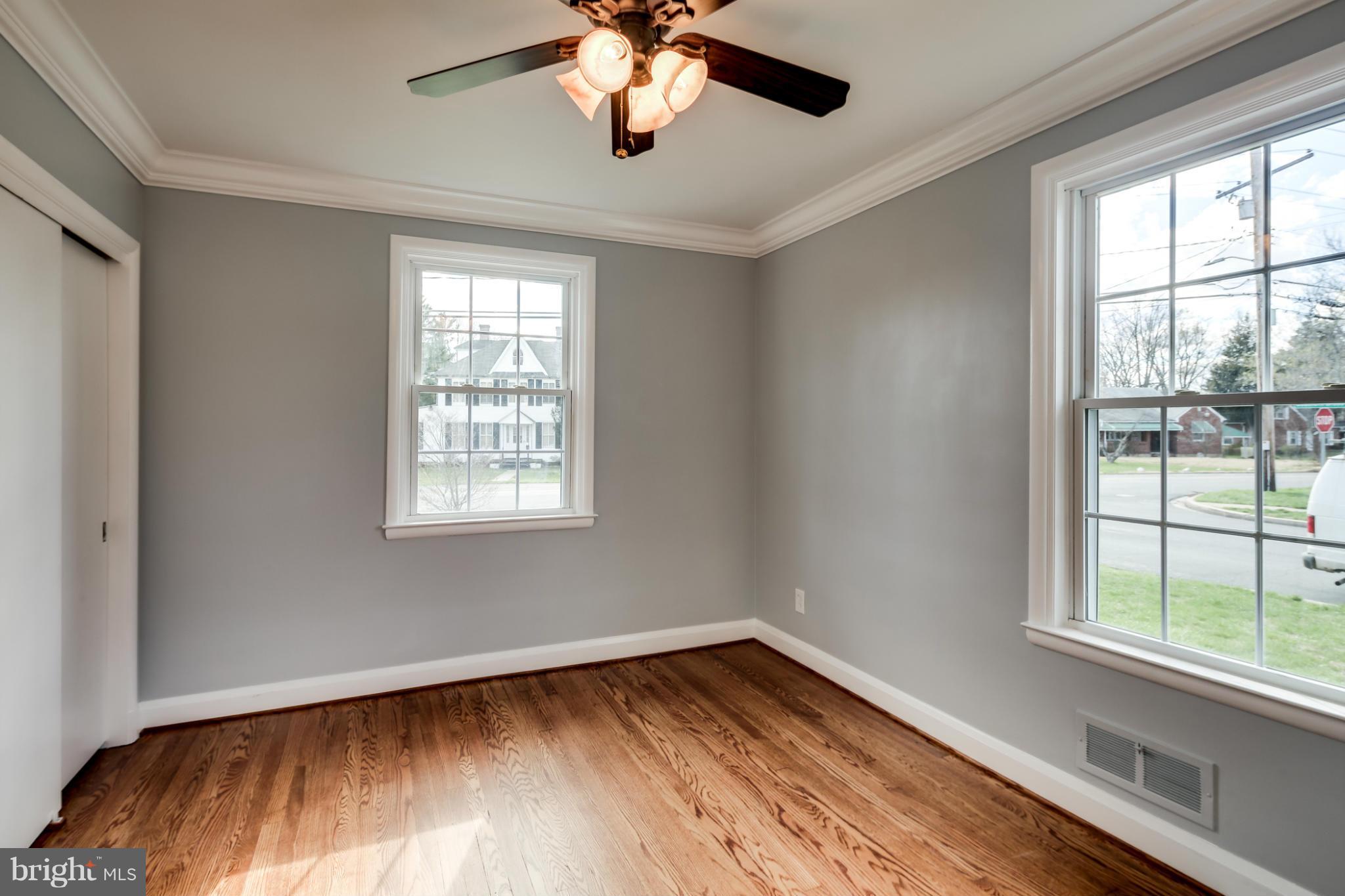 6704 Campfield Road Baltimore, MD 21207 - Photo 15 of 30 a view of empty room with wooden floor and fan