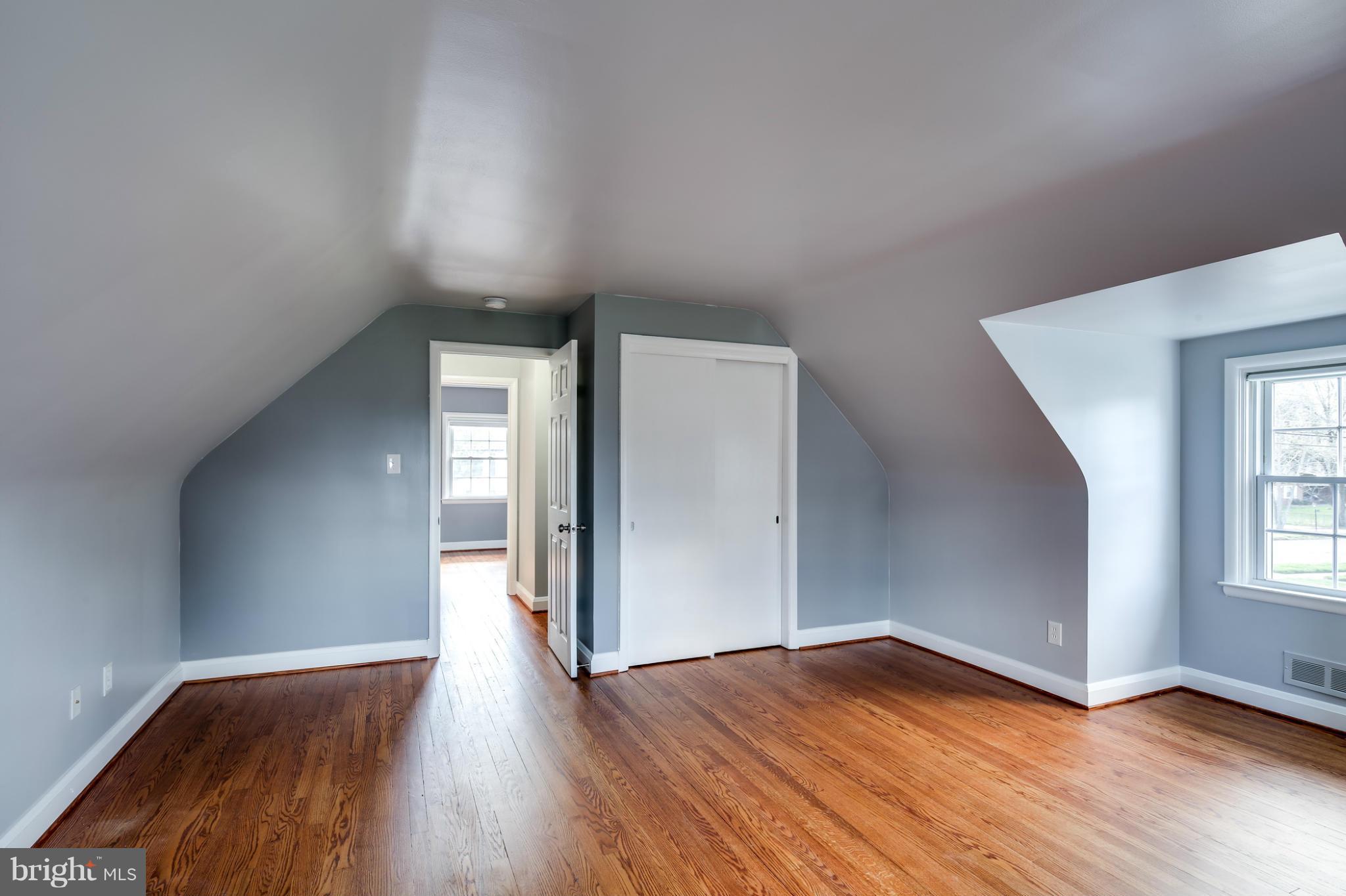 6704 Campfield Road Baltimore, MD 21207 - Photo 18 of 30 an empty room with wooden floor and windows