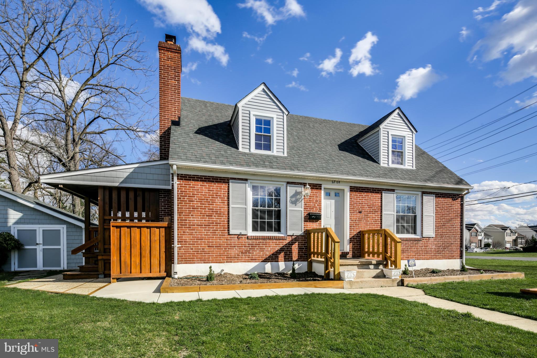 6704 Campfield Road Baltimore, MD 21207 - Photo 3 of 30 a front view of a house with a yard and porch