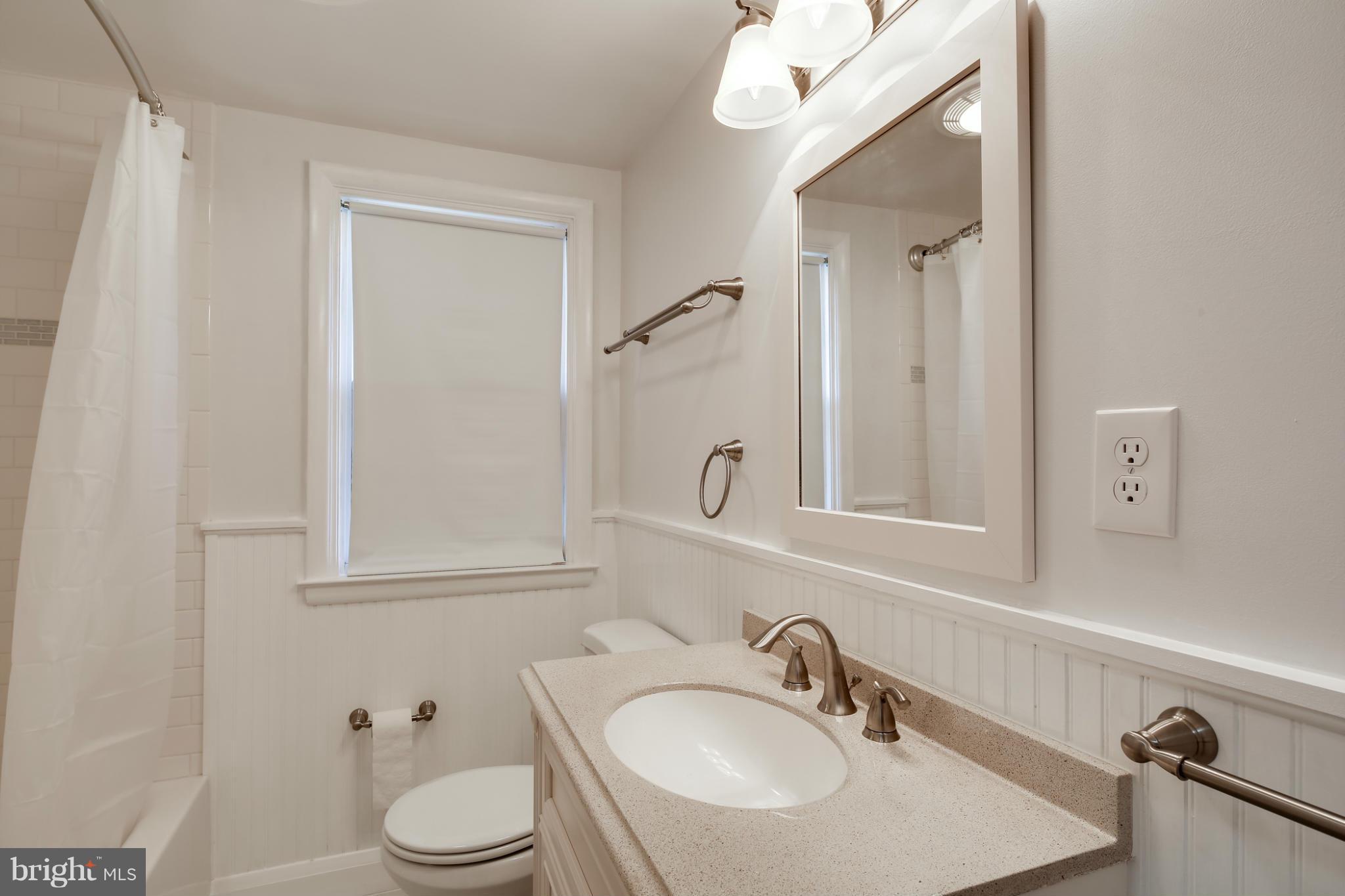 6704 Campfield Road Baltimore, MD 21207 - Photo 22 of 30 a bathroom with a sink toilet a mirror and shower