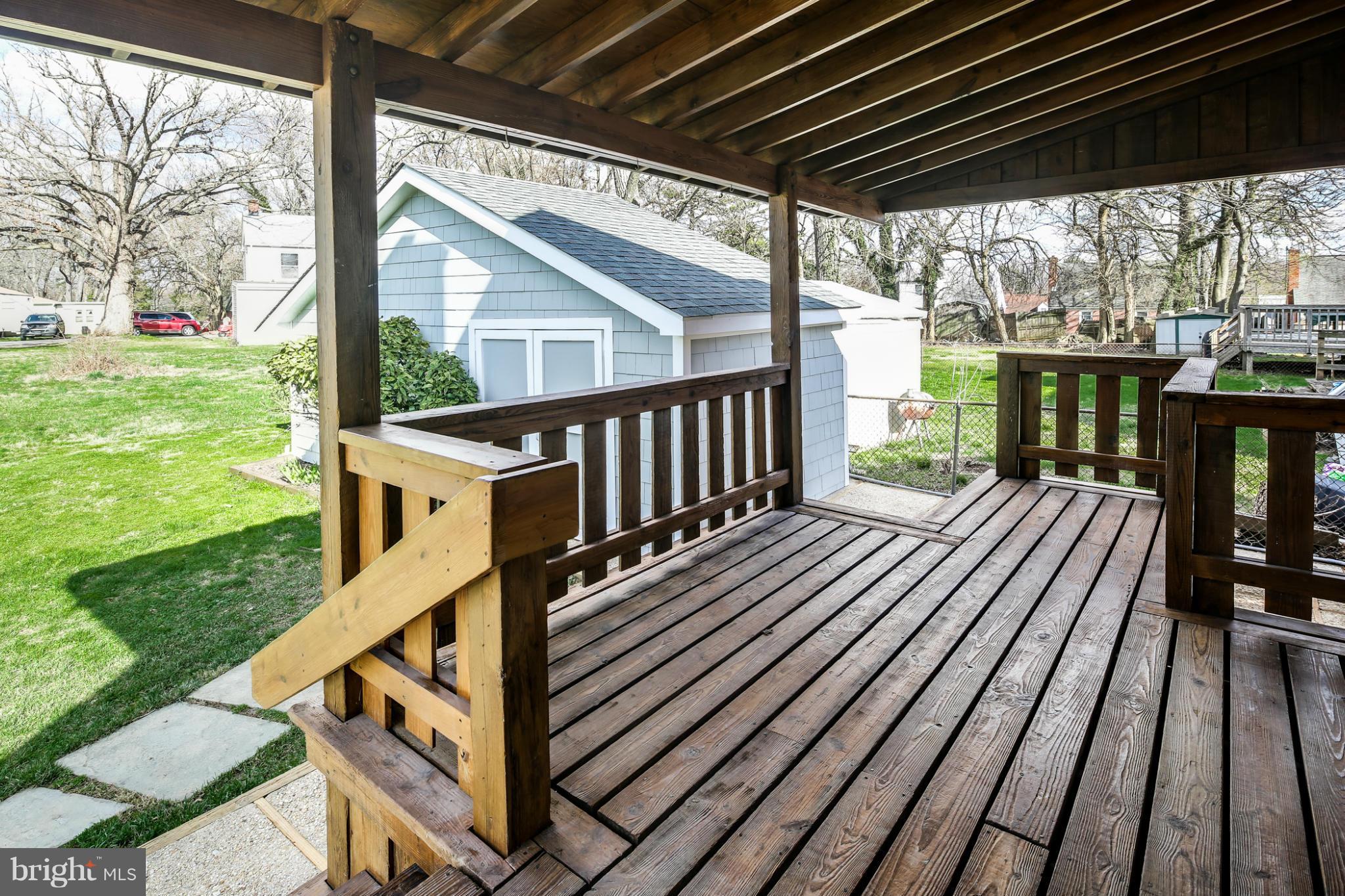6704 Campfield Road Baltimore, MD 21207 - Photo 27 of 30 a view of backyard with deck and wooden floor