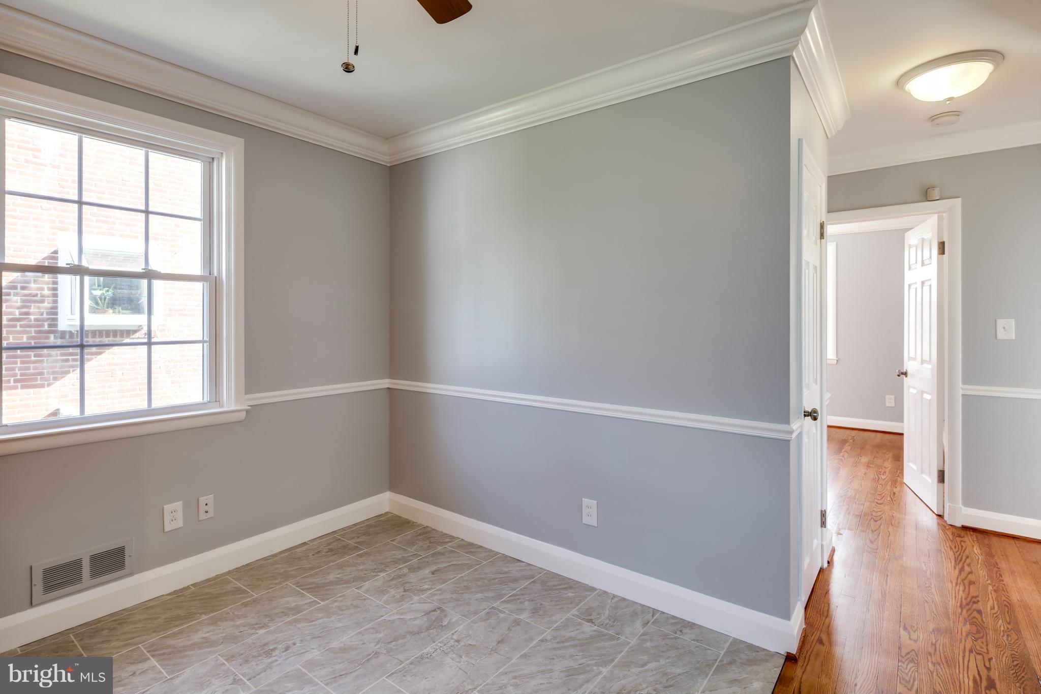 6704 Campfield Road Baltimore, MD 21207 - Photo 10 of 30 an empty room with wooden floor and windows