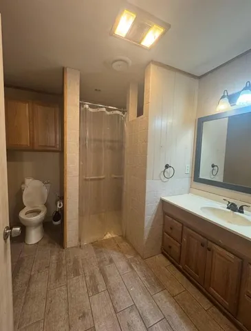 a bathroom with a sink toilet and shower