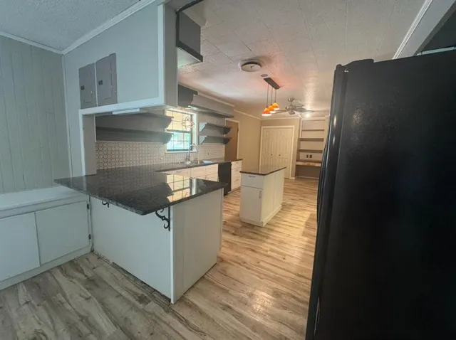 a kitchen with stainless steel appliances granite countertop a refrigerator and a sink