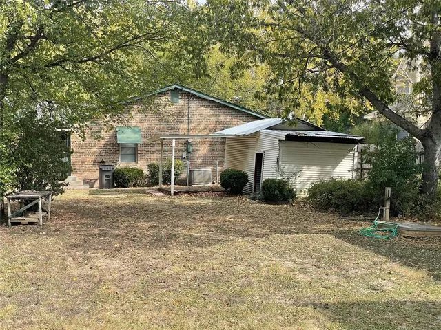 a view of a house with backyard and sitting area