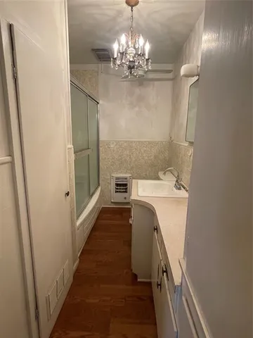a view of a bathroom with a sink and chandelier