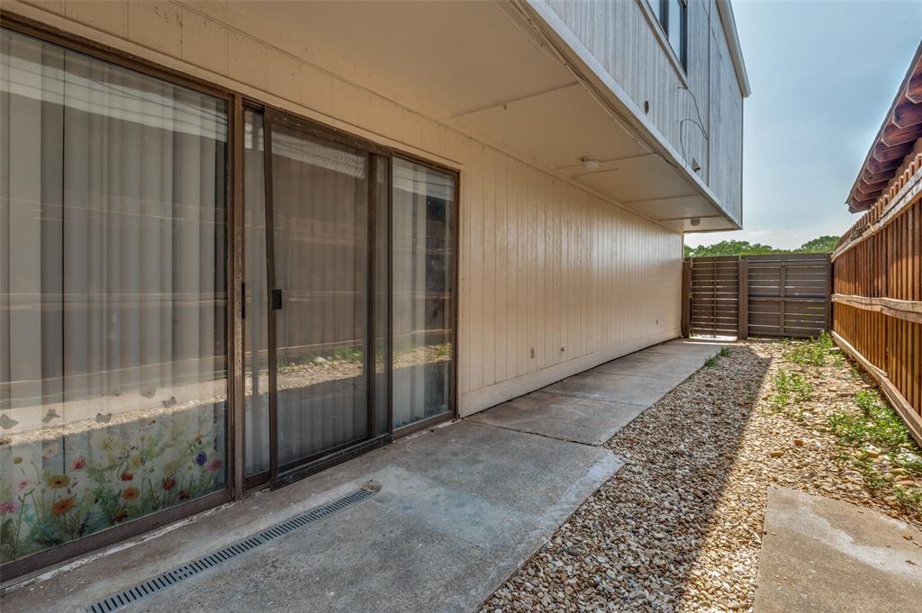 622 West Union Bower Road Irving, TX 75061 - Photo 13 of 13 Sliding glass doors opening onto a concrete patio with an integrated drainage system