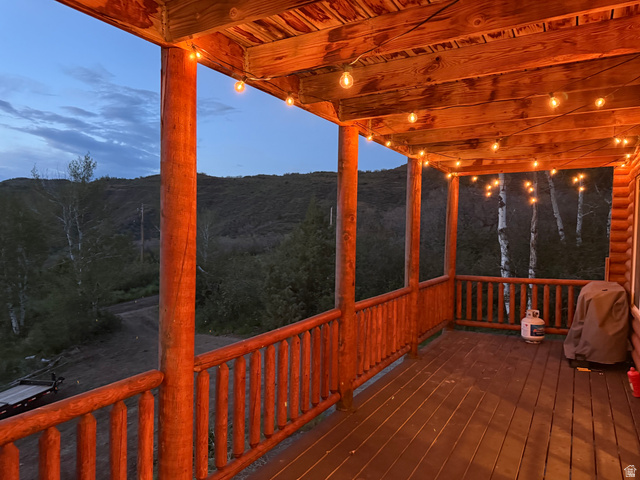 15253 Mill Road, Unit 62 Huntsville, UT 84317 - Photo 48 of 48 Expansive covered deck featuring a wood-finish floor, wood posts, and string lighting
