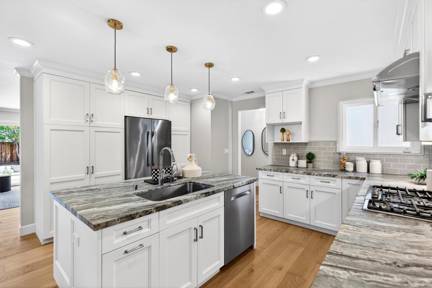 1422 Wright Avenue Sunnyvale, CA 94087 - Photo 14 of 34 a kitchen with stainless steel appliances a sink stove and refrigerator