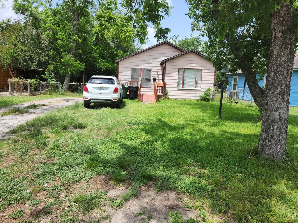 4215 Edison Street Houston, TX 77009 - Photo 2 of 13 a front view of a house with a garden and trees